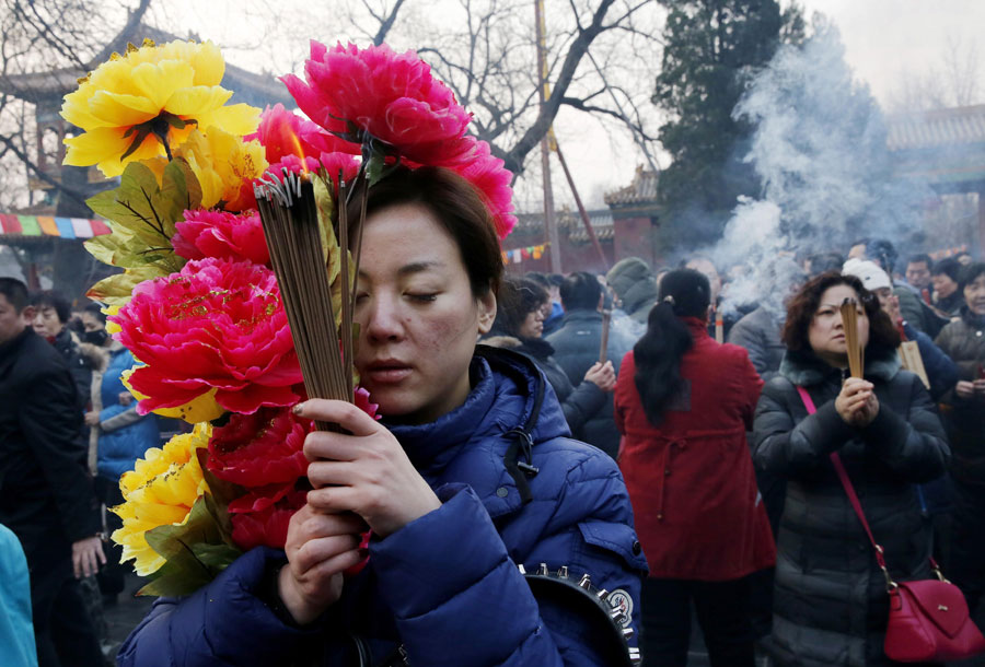 People pray on the first day of Chinese New Year