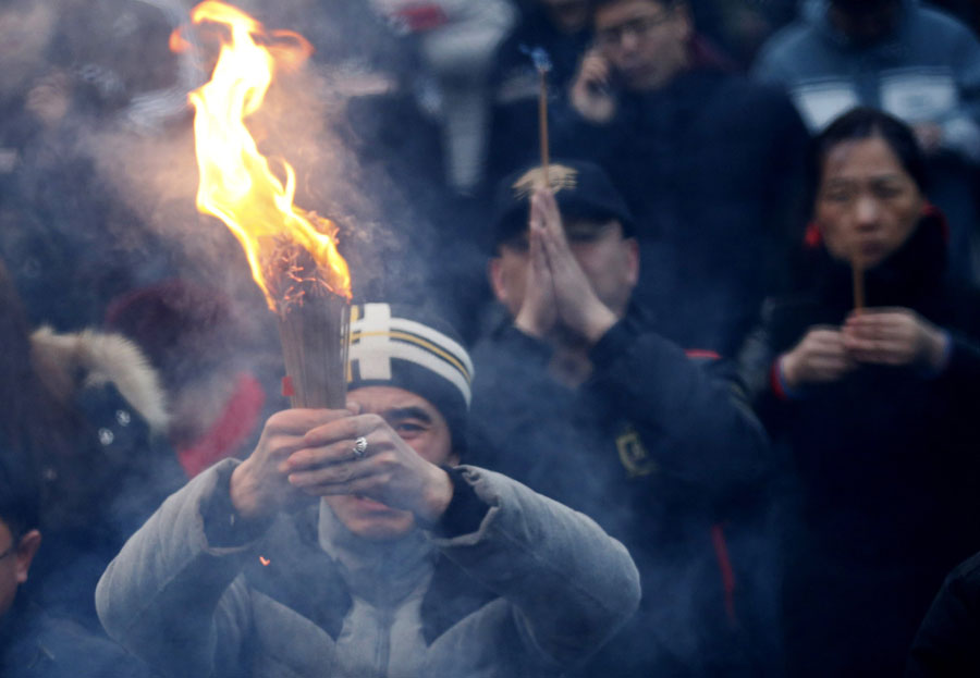 People pray on the first day of Chinese New Year