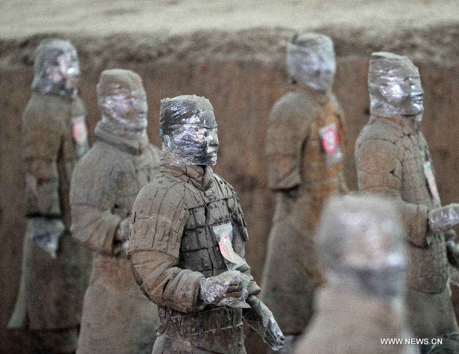 Terracotta warriors wrapped in cling film for protection of remnant painting