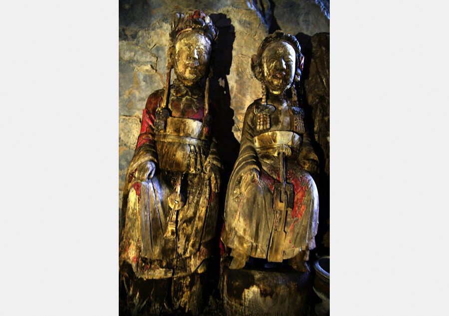 Wood sculptures discovered inside cliffside cave in Chongqing