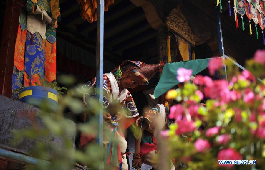 Tibetan Buddhist monks perform cham dance during ritual