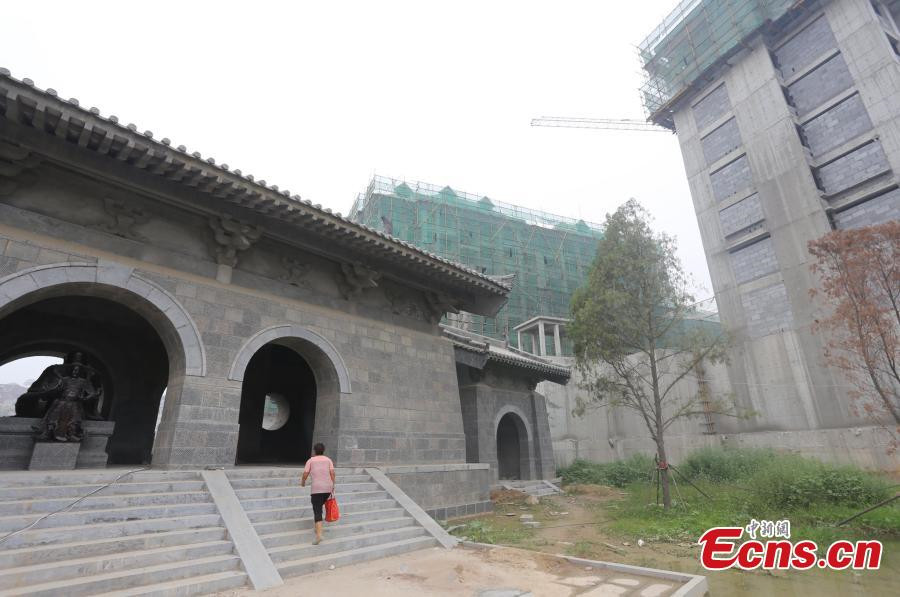 1,800-year-old temple under siege from high buildings in C China