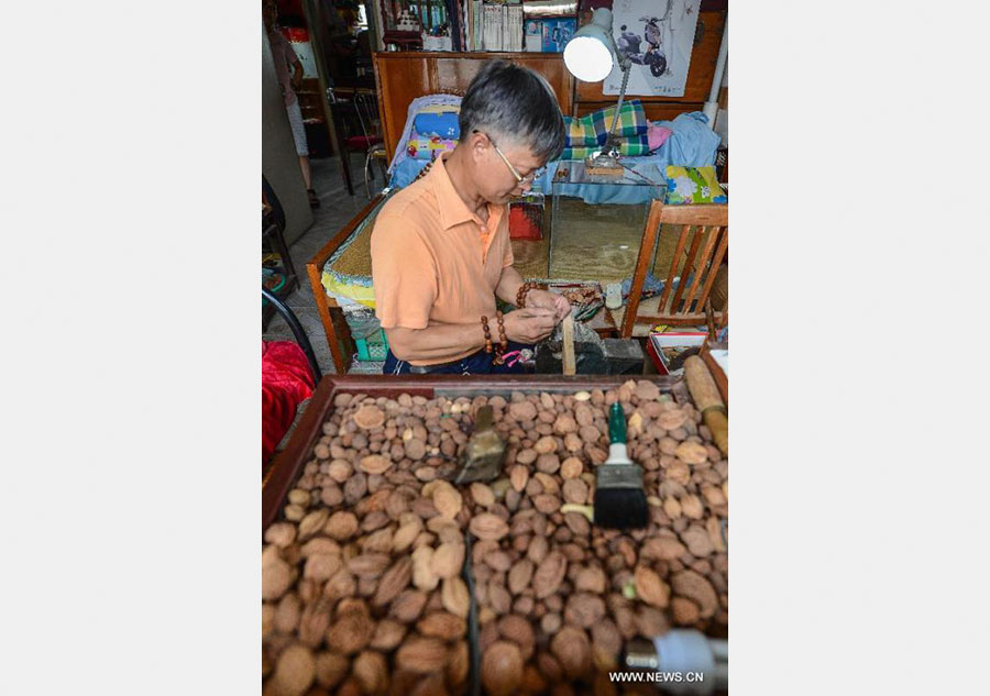 Peach pit carving: Chinese folk art on fingertips