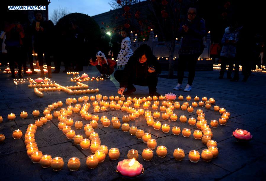 People pray for good luck at Guangren Temple in NW China