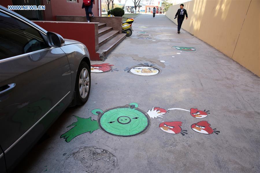 Cartoon figures painted on manhole covers in Shandong