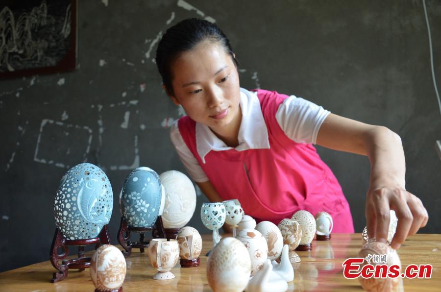 Disabled woman empowered by egg shell carving