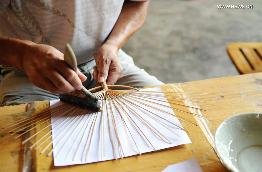 Traditional moon-shaped fan made in Guangxi