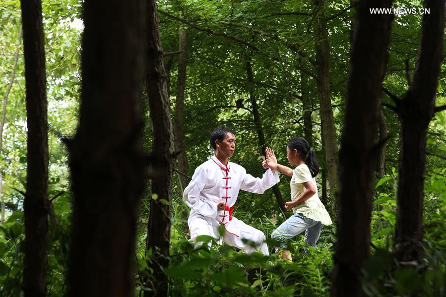 Children learn about Chinese Wushu during summer vacation in SW China