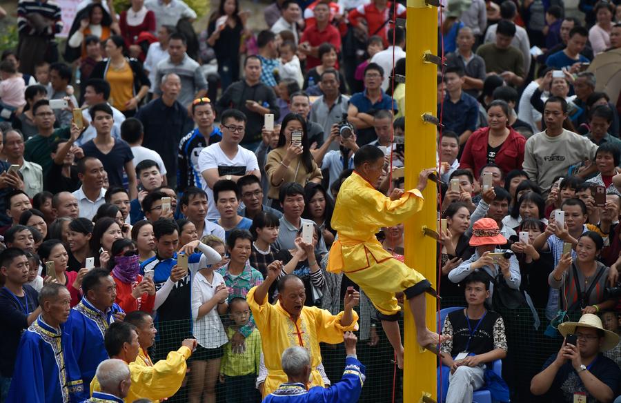 Stunt 'climbing on blades' performs in China's Fujian province