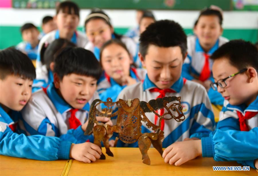Shadow puppet artists teach students traditional culture in N China
