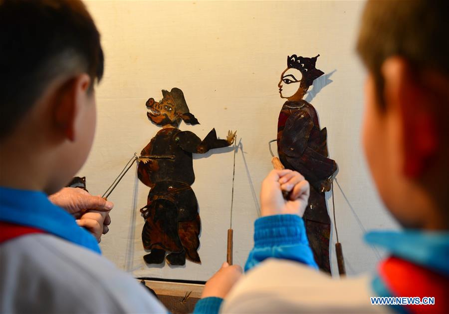 Shadow puppet artists teach students traditional culture in N China