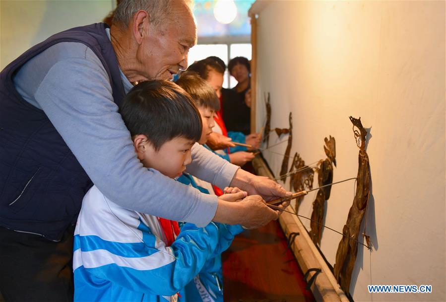 Shadow puppet artists teach students traditional culture in N China