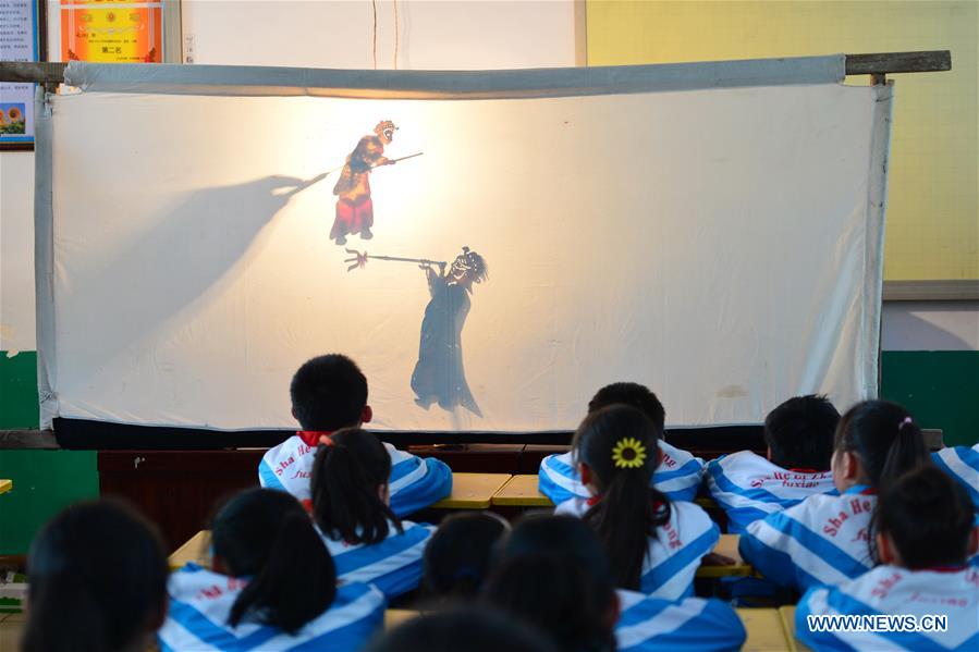 Shadow puppet artists teach students traditional culture in N China