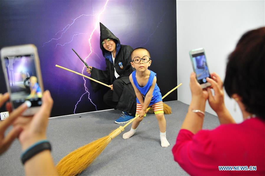 Visitors create their own photos at photo studio exhibition in Beijing