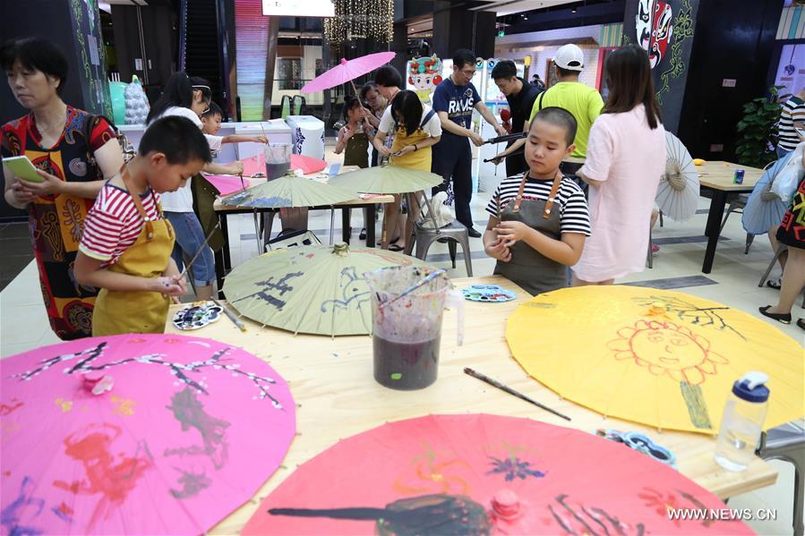 Children learn traditional intangible cultural heritages in E China