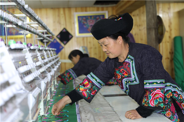Traditional attire helps Miao women earn a living