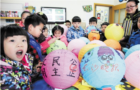 Children from Changsha, Hunan province, paint lanterns to celebrate the upcoming New Year