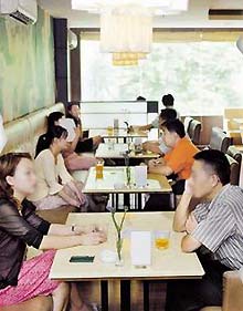 Some 28 single young men and women chat in pairs across the table in a downtown cafe in Shanghai. 