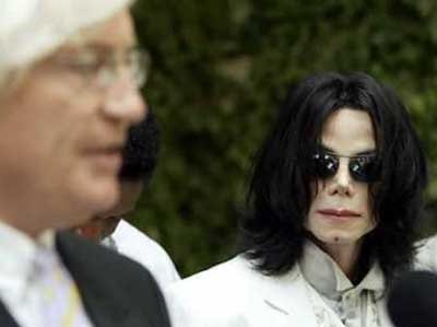 Entertainer Michael Jackson (R) listens as his attorney Thomas Mesereau speaks at a news conference, following Jackson's court appearance in Santa Maria, California September 17, 2004. Under the piercing gaze of Michael Jackson and his family, the mother of the teenage boy who accuses the pop star of molesting him sparred with lawyers at a hearing to determine what evidence can be allowed in the case. [Reuters]