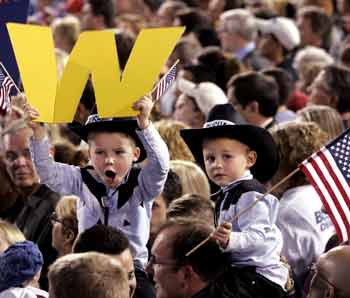 Two young boys sporting cowboy hats anxiously await the arrival of U.S. President George W. Bush at a campaign rally in Pontiac, Michigan, October 27, 2004. President Bush and Democratic opponent, Massachusetts Sen. John Kerry, battled on Wednesday over missing explosives in Iraq as they raced across vital swing states in the last days of a deadlocked White House race. [Reuters]