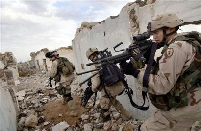 U.S. Army soldiers search for insurgents suspected of planting a roadside bomb in Mosul, Iraq Sunday, Nov. 21, 2004. U.S. and Iraqi forces in Mosul have been working to put down an uprising launched by guerrillas who seized police stations and other sites. The uprising was part of a wave of violence across the country coinciding with the U.S. offensive against the insurgent stronghold of Fallujah. [AP]