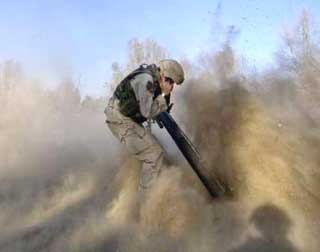 U.S. Specialist Paul Sakala, from the 4th Cavalry Regiment of the 1st Infantry Division, fires a 120mm mortar at insurgents near Forward Operating Base Wilson, north of the Iraqi capital Baghdad, in this picture taken on November 29, 2004. As well as near daily attacks on Iraqi security forces and civilians, November has been one of the deadliest months for U.S. troops, with 134 killed. The highest death toll was in April this year, when 135 soldiers and Marines were killed. Picture taken on November 29, 2004. 