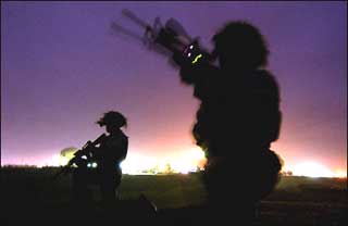 Two US soldiers during a night patrol in Iraq. The Pentagon said it will raise US force levels in Iraq from 138,000 to about 150,000 by late December or early January, ahead of the country's first elections since Saddam Hussein's ouster. [AFP]