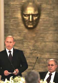 Russian President Vladimir Putin, left, makes a speech as his Turkish counterpart Ahmet Necdet Sezer listens during a dinner at the Presidental Palace of Cankaya in Ankara, Turkey, Sunday Dec. 5, 2004. Russian President Vladimir Putin made the first official visit by a Russian leader to Turkey, looking to strengthening an economic relationship that is turning a country that has been a foe since the times of the Ottomans and the czars into a newfound trading partner. Putin was to have dinner with President Ahmet Necdet Sezer before official talks Monday. A bust of Turkey's founder Ataturk is seen in the background. [AP] 
