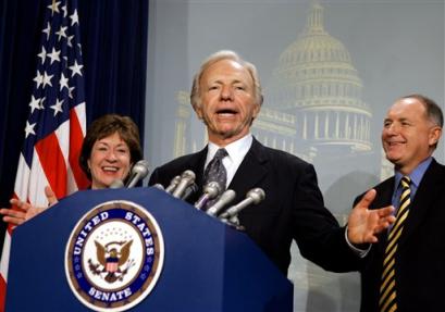 'Praise the Lord, we passed the bill,' exclaims Sen. Joe Lieberman), center, with Sen. Susan Collins at left, and House Intelligence Committee Chairman Rep. Peter Hoekstra, right, after the Senate voted 89-2 in favor of legislation to overhaul the nation's intelligence structure, on Capitol Hill in Washington, Wednesday, Dec. 8, 2004. Collins and Lieberman led Senate negotiators on the intelligence reform bill and co-authored the original Senate version. [AP]