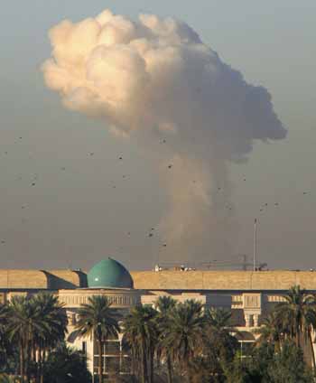 A column of smoke rises after a powerful car bomb exploded at a checkpoint leading into the so-called "Green Zone" in Baghdad December 13, 2004. The building in the foreground comprises part of the U.S. Embassy in Baghdad, which was not directly affected by the blast. There were no immediate reports on injuries or deaths. [Reuters]