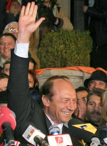 Bucharest's popular mayor Traian Basescu gestures after the first exit polls showing him and Romania's Prime Minister Adrian Nastase virtually neck-and-neck from the second round of presidential elections in Bucharest, December 12, 2004. The ruling Social Democrats badly need a Nastase victory to hold on to power in the European Union candidate country following inconclusive parliamentary elections two weeks ago. [Reuters]