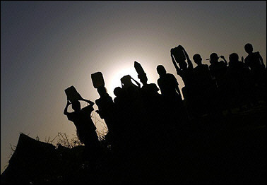 Displaced Sudanese carry buckets of water at the Otash refugee Camp on the outskirts of Nyala, in Sudan's Darfur region. Rebel leaders pulled out of peace talks on the crisis in the western Sudanese region of Darfur, accusing the government of repeatedly breaching a ceasefire deal, spokesmen for their movements said. [AFP/File]