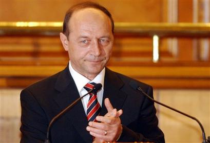 Romanian President Traian Basescu applauds after being sworn in as the new Romanian president during a special session of parliament in Bucharest, Romania, late Monday night Dec. 20, 2004. [AP]