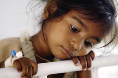 Kamalvathi, a survivor of Sunday's devastating tsunami, undergoes treatment in Cuddalore, 112 miles south of the Indian city of Madras, December 28, 2004. Aid agencies struggled on Tuesday to cope with the scale of the Asian tsunami disaster which has killed more than 38,000 people, with the International Red Cross saying it may have to treble its appeal for funds. [Reuters]