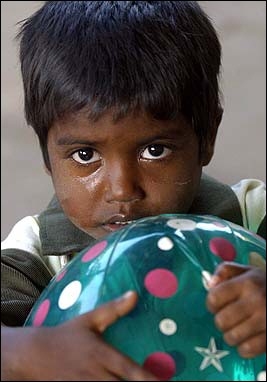 A young Indian boy, who lost his parents in last week's tsunami, clings onto a ball while crying at an orphan shelter in Nagapattinam. Humanitarian groups warned against westerners rushing to adopt Asian children orphaned by the tsunami disaster.[AFP]
