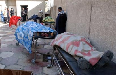 Bodies of victims wait to be taken away for burial outside Yarmouk hospital in Baghdad, Sunday, Jan. 9, 2005. At least five Iraqis, including two policemen and three civilians, were killed the previous night when U.S. troops opened fire after their convoy was struck by a roadside bomb at a checkpoint south of Baghdad, police said. [AP]