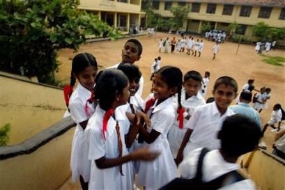 School girls laugh and talk on the first day back to classes after the tsunami in the town of Panadura, Sri Lanka Monday Jan. 10, 2005. Some 8,000 children will start lessons in makeshift school rooms - some in tents pitched near their destroyed schools, some in buildings that did not fall and some using emergency 'school-in-a-box' kits provided by UNICEF consisting of exercise books, pencils, chalk, teaching aids and some puzzles. [AP]