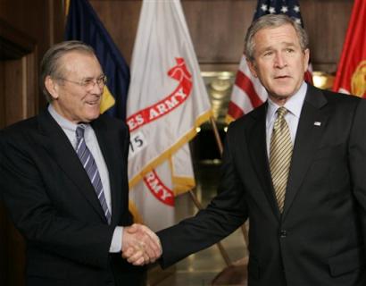 US Secretary of Defense Donald Rumsfeld and President Bush shake hands, Thursday, Jan. 13, 2005 following a briefing at the Pentagon on the war on terrorism and an update from commanders on the ground dealing with the tsunami crisis in Asia. [AP]