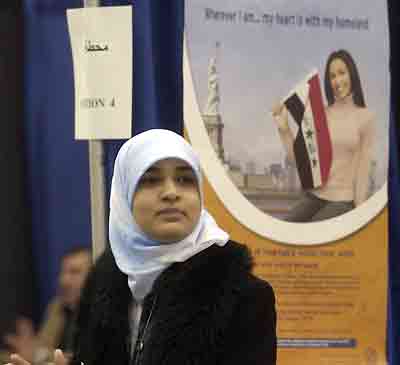 19-year-old Iraqi-born poll worker Manal Al-Mosawi waits to assist Iraqi expatriates as they registered to vote in the upcoming national elections, at a polling station set up in Southgate, Michigan January 17, 2005. Iraqis living outside the country can vote in the election if they are over 18 years old and were born in Iraq, or if their father was born in Iraq. [Reuters]