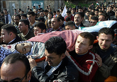 Palestinians carry the body of 14-year-old Salah Ikhab during his funeral in Tubas, south of the West Bank town of Jenin. The boy was shot by Israeli soldiers while playing with a toy gun which he had been given as a present, witnesses said. [AFP]