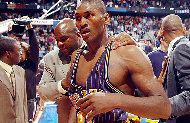 Ron Artest (R) of the Indiana Pacers is escorted out of the Palace by Chuck Person following a melee on 19 November 2004. The NBA had argued that arbitrator Roger Kaplan had no authority to hear an appeal of Stern's bans of O'Neal, Artest, Stephen Jackson and Anthony Johnson of the Pacers for their roles in the melee.(AFP) 