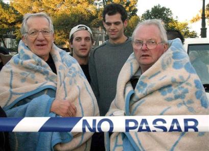 Guests from the Port Denia hotel wait outside wrapped in blankets after a bomb exploded inside the hotel in Denia, Spain Sunday. Jan. 30, 2005. The bomb exploded in the Mediterranean resort hotel in southeast Spain after a telephone warning from the Basque separatist group ETA, injuring one person. (AP Photo/EFE, Pep Morell) 