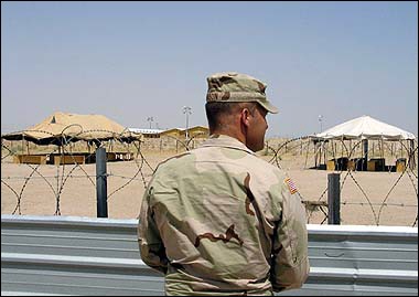 A US military officer stands in front of the visitation area at the Camp Bucca detention camp on the outskirts of Umm Qasr. [AFP/File]