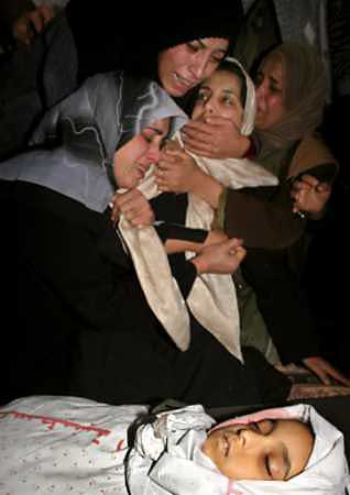 Palestinian women mourn over the body of a 10-year-old girl during her funeral in Rafah refugee camp January 31,2005. Israeli army gunfire killed Noran Deeb in a schoolyard in the southern Gaza Strip on Monday, witnesses said, in an incident that clouded a new spirit of Israeli-Palestinian cooperation. [Reuters]