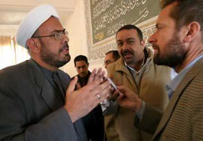 Muhammed Bashar al-Faidhi(L), a Sunni cleric, discusses Iraq (news - web sites)'s recent elections with reporters in Baghdad February 2, 2005. A leading group of Iraqi Sunni clerics said on Wednesday any government emerging from Iraq's landmark election would lack legitimacy because many people had boycotted a poll they said was tainted by a U.S.-led occupation. (Ali Jasim/Reuters) 