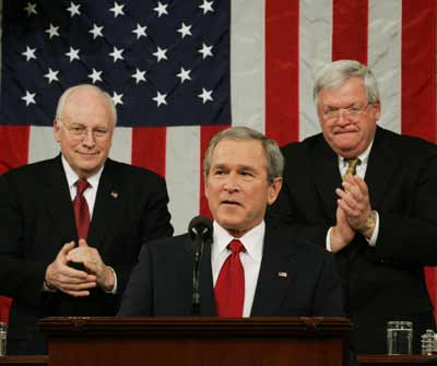 U.S. President George W. Bush pauses as Vice President Dick Cheney (L) and House Speaker Dennis Hastert (R) applaud at the start of his State of the Union address at the U.S. Capitol in Washington, February 2, 2005. The State of the Union speech is an annual exercise to lay out the president's top goals for the year, and for Bush, it will outline priorities for his second term. [Reuters]