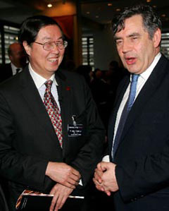 Zhou Xiaochuan, governor of the People's Bank of China or the central bank, meets with British Chancellor of the Exchequer Gordon Brown at the G7 finance ministers meeting in London Feb. 5. He said China is very much on track in the exchange rate reform for a flexible exchange regime. [Xinhua]