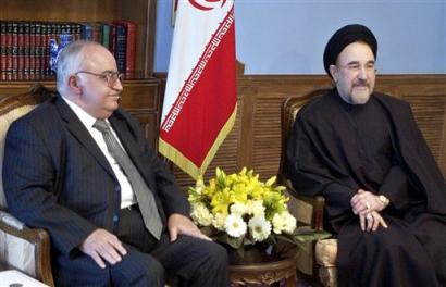 Iranian President Mohammad Khatami, right, and Syrian Prime Minister Mohammed Naji al-Otari, talk during an official meeting at Saad Abad palace in Tehran, Iran, Thursday, Feb. 17, 2005. Iran and Syria, who both are facing pressure from the United States, said Wednesday they will form a united front to confront possible threats against them, state-run television reported. [AP]