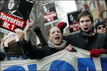 Protestors shout slogans and hold banners reading 'Terrorist number one' during a demonstration against US President George W. Bush in Mainz, where Bush met German Chancellor Gerhard Schroeder on February 23, 2005. [AFP]