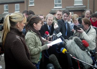 Claire, the sister of slain man Robert McCartney, speaks to the media as Bridgeen Higgans Robert's partner stands by at left, in the Catholic Short Strand area of East Belfast, Northern Ireland, Wednesday, March 9, 2005. They are giving their response to the recent Irish Republican Army(IRA) statement which stated that they offered to shoot those involved in the killing of Robert McCartney outside of a Belfast pub on Jan. 30, 2005. [AP]